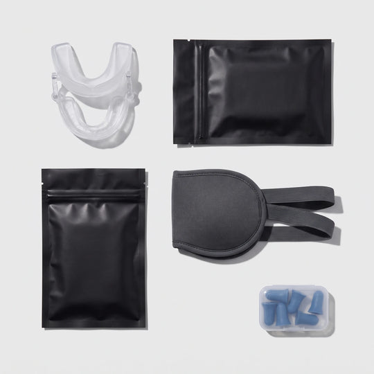 The Whole Night bundle — Nightpiece Pro, nasal strips, mouth tape, sleep mask and earplugs laid out flat