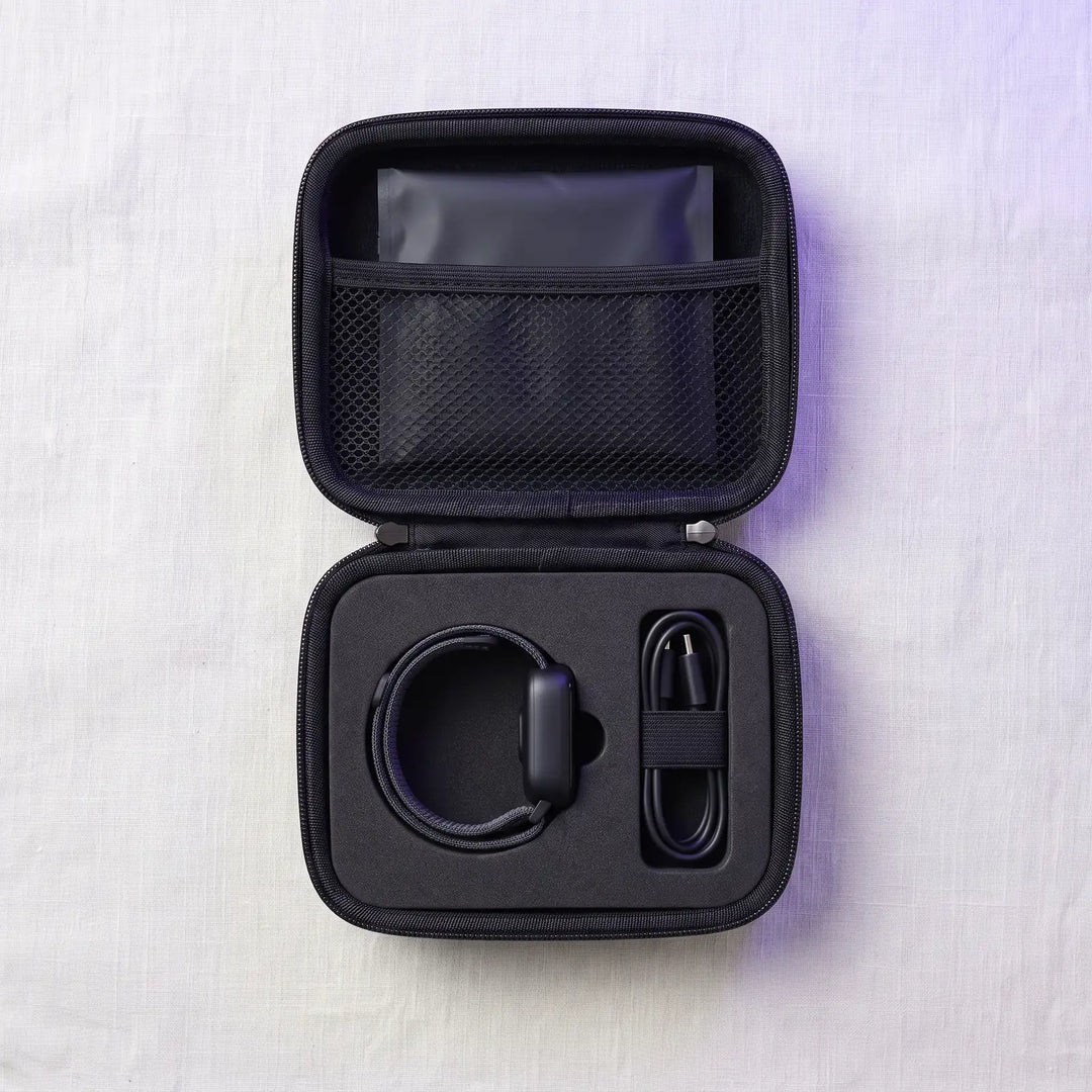 The case open flat, showing the foam bed for the alarm, the cable loop and the lid pocket