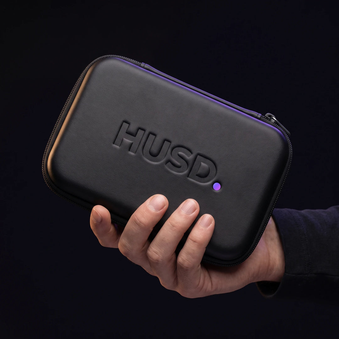 The closed case held in one hand, showing it is smaller than the palm