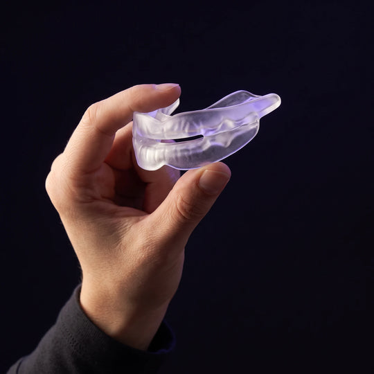 The Nightpiece held between finger and thumb, showing it is smaller than a palm