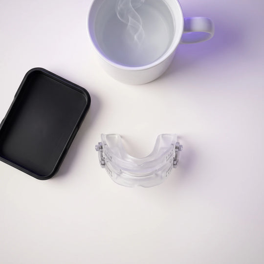 The fitting kit laid out from above: the Nightpiece, a black fitting tray and a mug of hot water