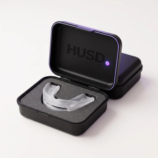 The Nightpiece resting in the foam bed of its open matte black HUSD case