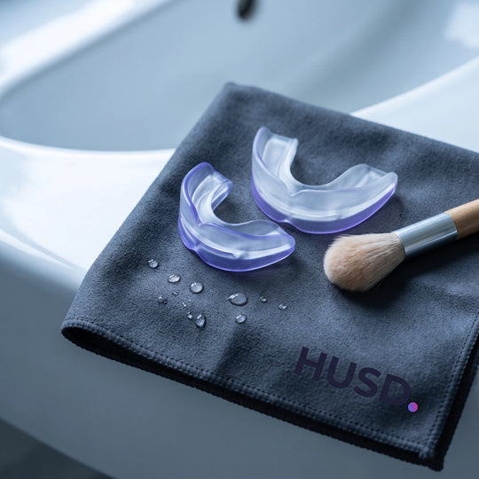 Both halves of the Nightpiece Pro drying on a charcoal cloth beside a cleaning brush