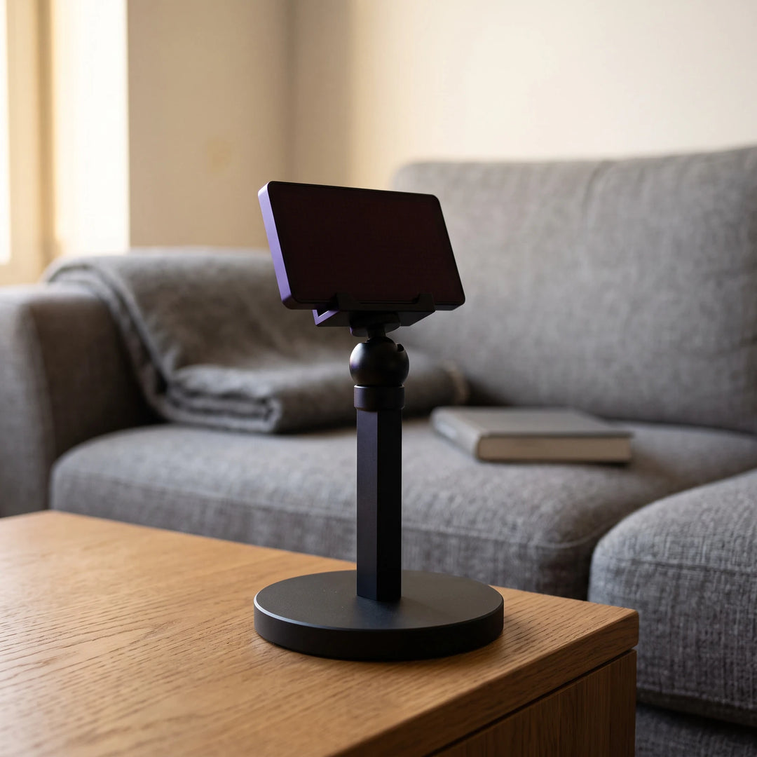 The stand on an oak side table beside a sofa, holding the unlit panel