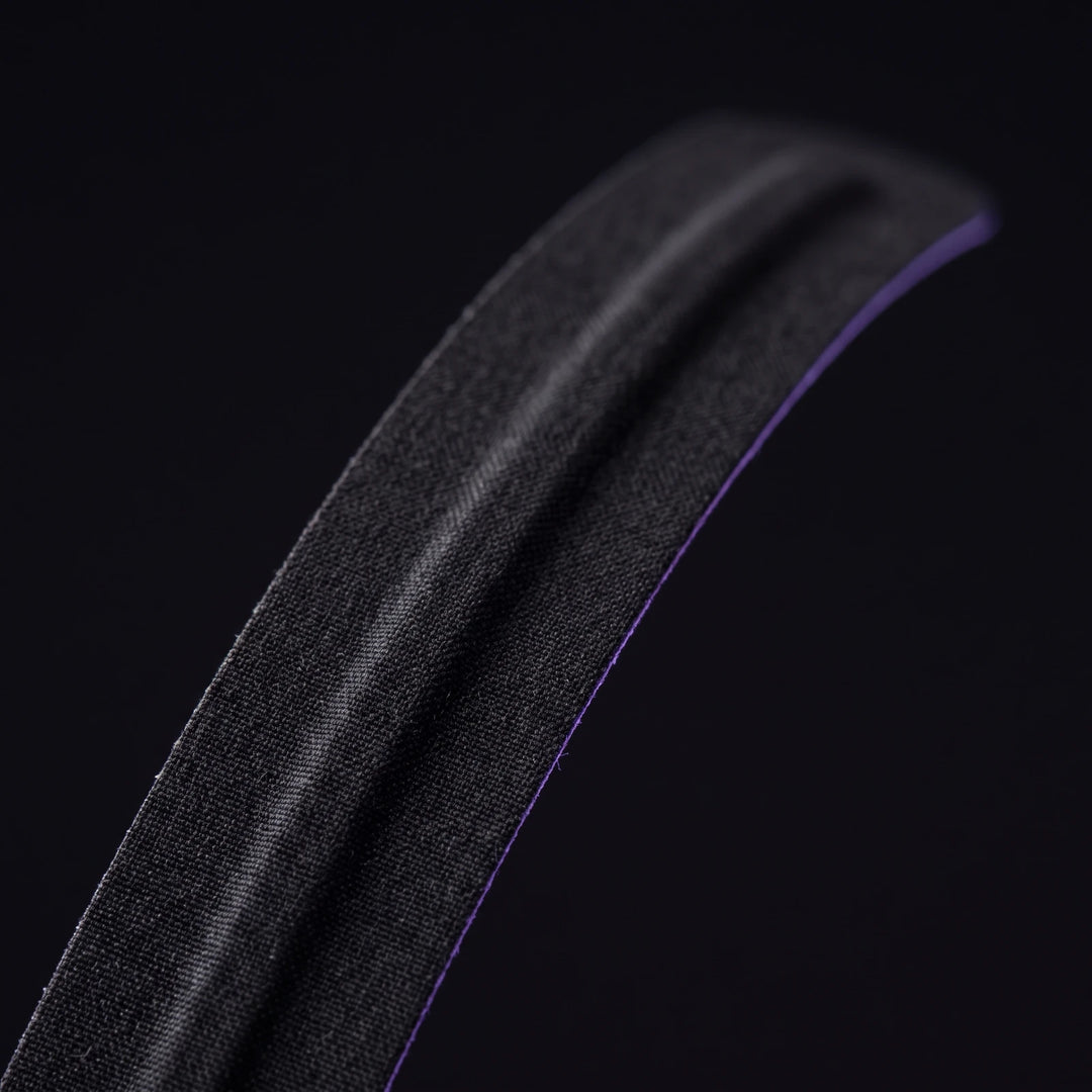 Macro of a single nasal strip showing the woven fabric surface and the spring core
