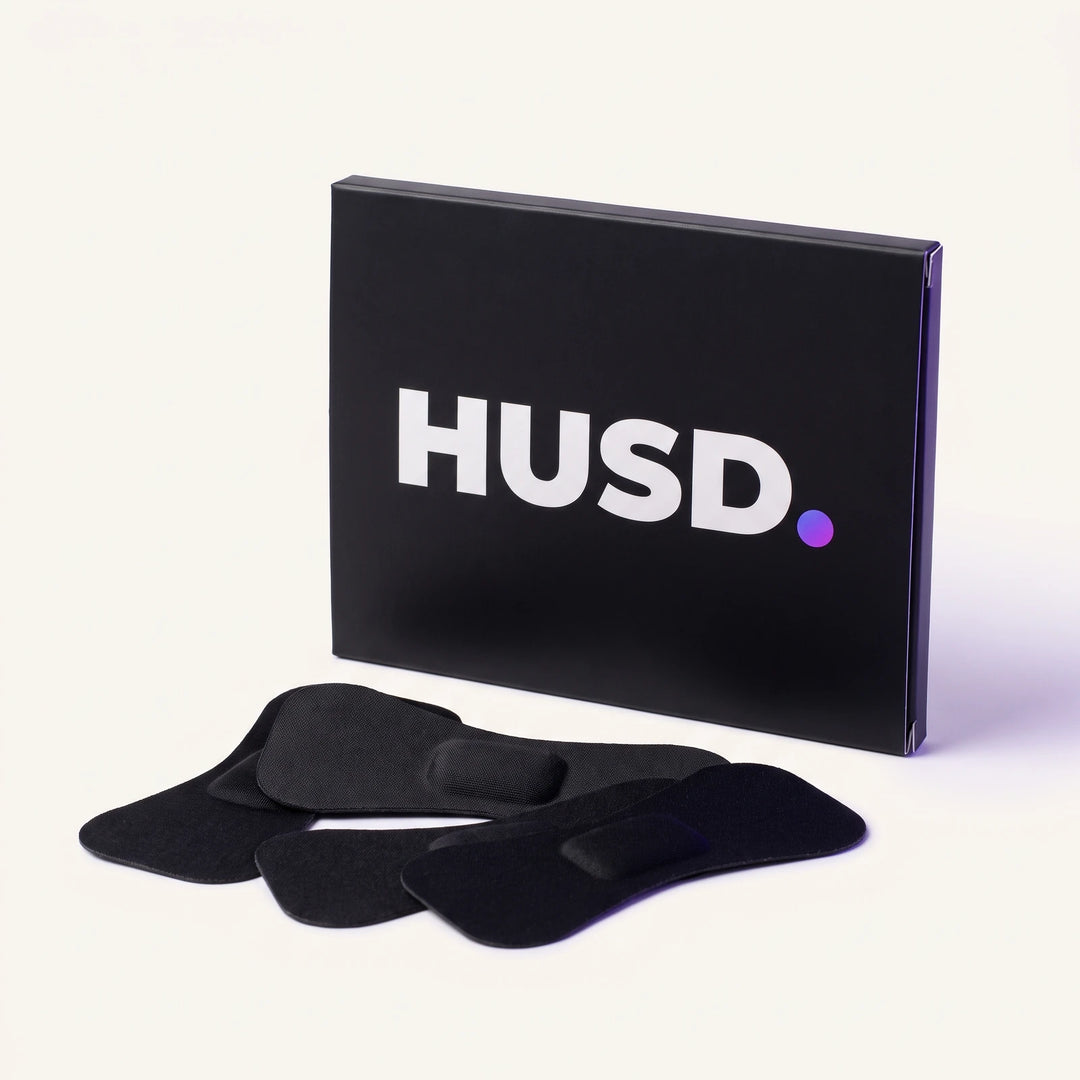 The HUSD mouth tape box standing upright with three bow-tie shaped strips in front of it