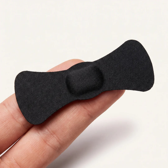 A single strip resting across two fingertips, showing how small it is